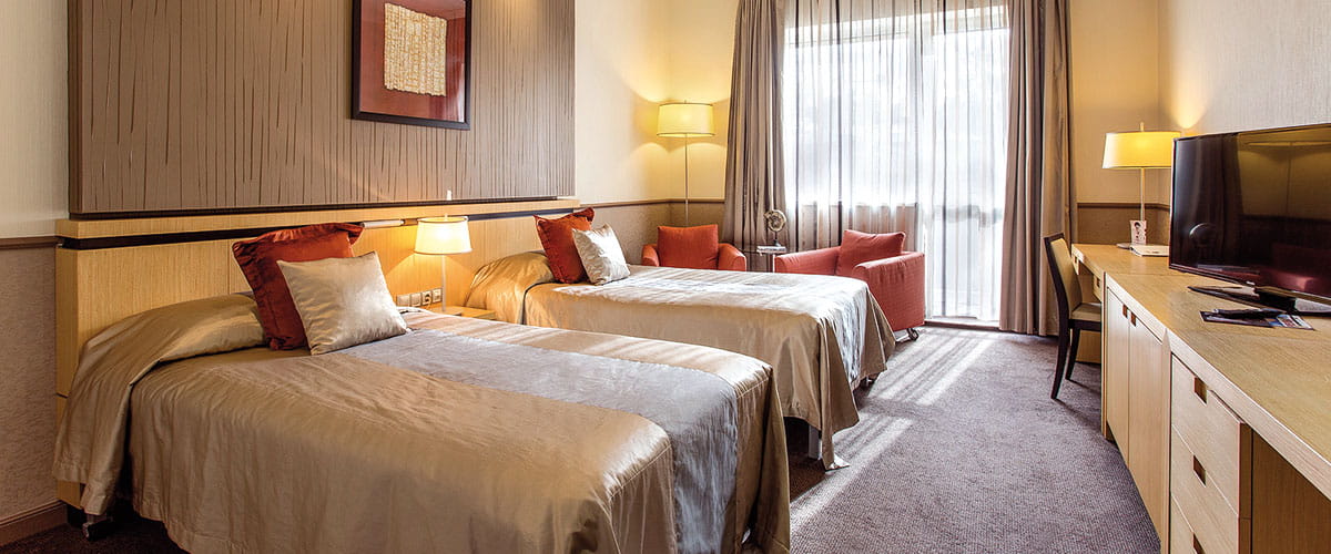 A Deluxe Twin bedroom in the Mamaison Andrassy Hotel, Budapest